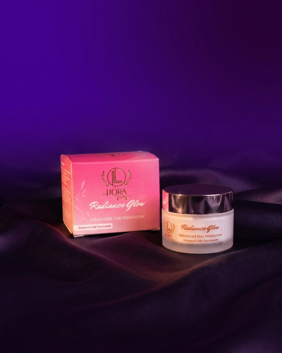 Radiance Glow Advanced Day Moisturizer, box and jar on dark satin